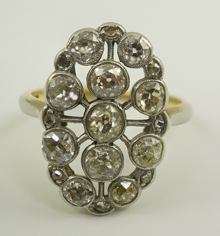 A 1940's 18ct gold, platinum and millegrain set diamond oval cluster ring